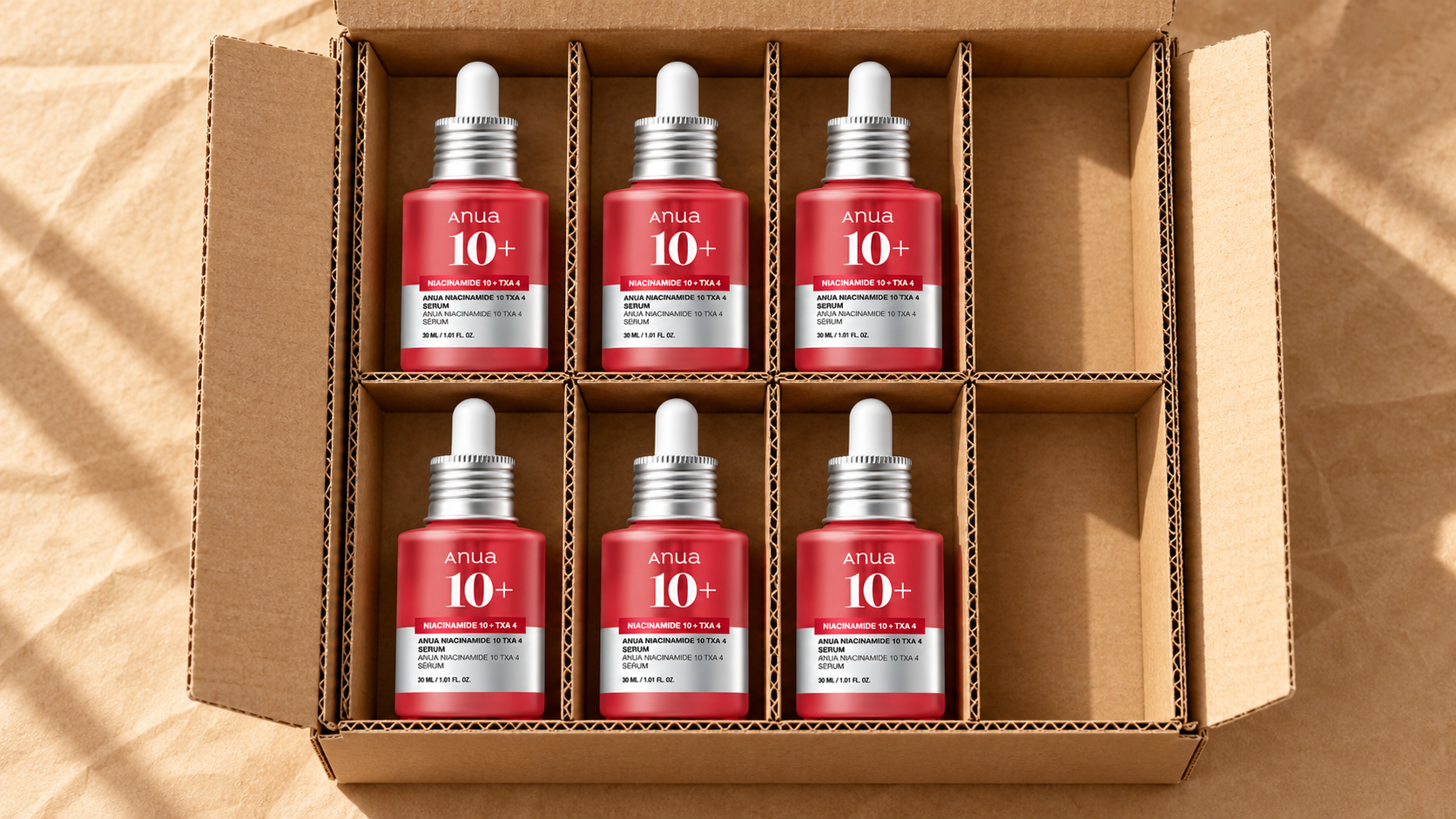 Six Anua serum bottles arranged in a wholesale packing tray to illustrate units per SKU.